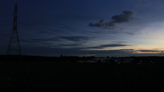 Natural video background of various trees growing along the edge of a large reservoir, with a cool breeze, colorful twilight sky, and the richness of the forest system.