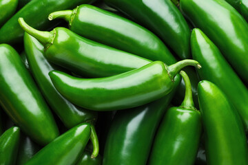 Many green jalapeno peppers as background, closeup