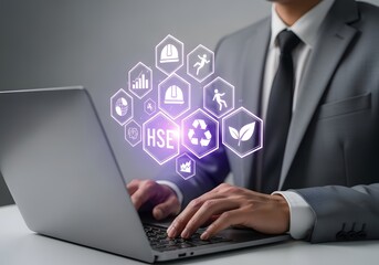 Businessman using laptop with digital hse icons for health safety environment management