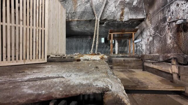 Transylvania, Romania, Aug 12, 2025: Old wooden lift with wheels and ropes transporting salt from the depths of Salina Turda salt mine in Transylvania. Romania