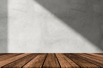Empty table on beige texture wall background. Composition with leaves shadow on the wall. Mock up for presentation, branding products, cosmetics food or jewellery.