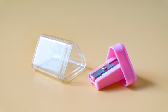 Pink pencil-sharpener on a over color background.
