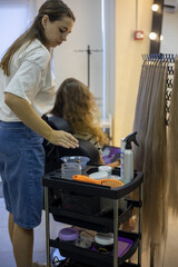 Hair styling session in a modern salon featuring vibrant colors and skilled hands at work