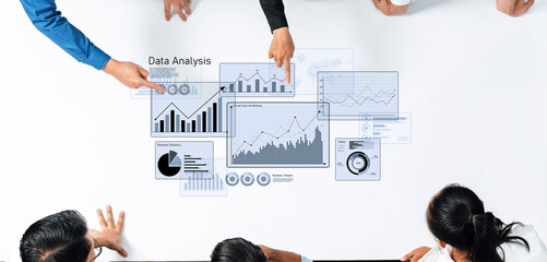 A diverse team engages in a collaborative meeting focused on data analysis, exploring charts and graphs to strategize business decisions using technology and visuals. Trope
