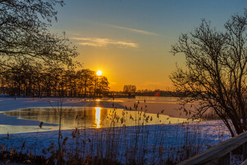 sunrise at the frozen lake