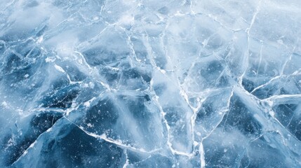 Obraz premium Cracked ice covers a body of water, showcasing intricate patterns and deep blue hues below. This wintery scene highlights natures artistry in a cold landscape.