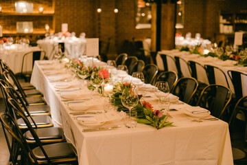 Elegant dining setup for a special event in a stylish restaurant space with warm lighting