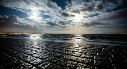 Dramatic Moonlit Ocean Shoreline with Paved Walkway.
