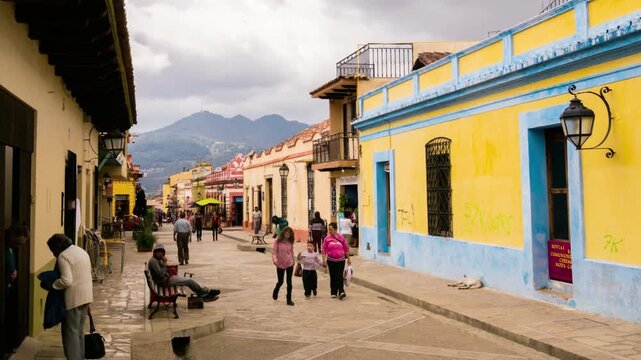 People stroll along a vibrant street in san cristobal de las casas, mexico