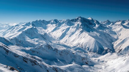 Obraz premium Snow blankets the towering mountains, creating a stunning winter landscape. The bright blue sky contrasts beautifully with the rugged terrain, inviting adventure and exploration.