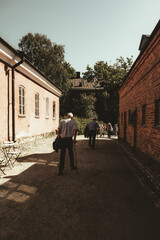 Elderly Men Walking Through Historic Alley