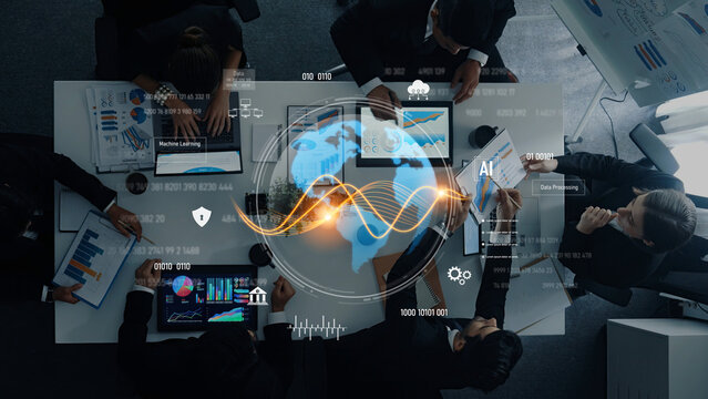 Diverse business professionals collaborate in a modern office, analyzing data and technology visuals displayed on various screens, highlighting teamwork and strategic planning. Trope