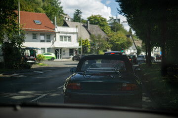 Street view with cars and houses on a sunny day