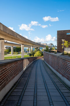 Path with brick walls and modern concrete in Stockholm urban architecture, geometric perspective and circulation forming minimalist Scandinavian composition for designers and creatives