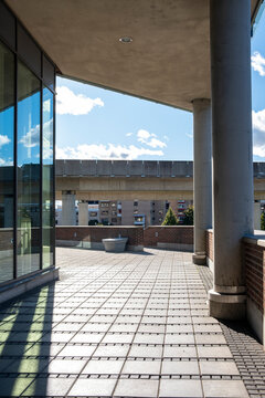 Glass reflections and concrete columns in Stockholm urban architecture, circulation and transparency blending with light and shadow, composition offering modern perspective for design