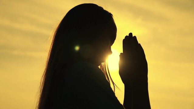 childhood dream of a happy childhood, silhouette of a teenager asking for help from God at sunset, praying for health at dawn, repenting of what he has done, faith in goodness and justice.