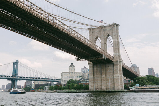 View of Brooklyn Bridge and Manhattan Bridge over the East River on a sunny day