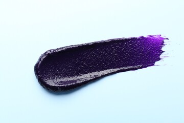 Sample of blonde hair care cosmetic product on light blue background, top view