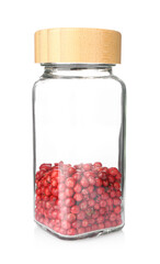Red peppercorns in glass jar isolated on white. Aromatic spice