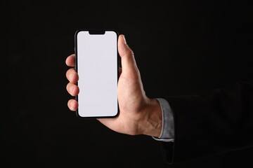 Man with modern smartphone on black background, closeup. Mockup for design