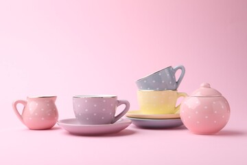 Beautiful tea set on pink background, space for text. Child's toy