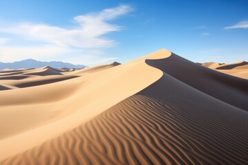 Golden sand dunes sculpted by wind under blue sky desert landscape