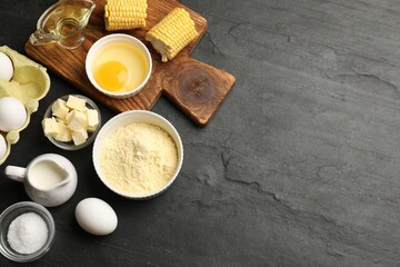 Cornbread preparation. Different ingredients on black textured table, flat lay. Space for text