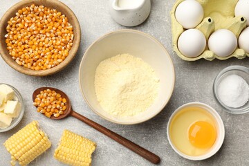 Cornbread preparation. Different ingredients on light grey table, flat lay