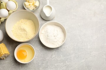 Cornbread preparation. Different ingredients on light grey table, flat lay. Space for text