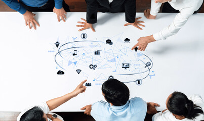 A diverse business team collaborates on a digital strategy, analyzing visual data over a table in a modern office, emphasizing teamwork and innovative solutions. Trope