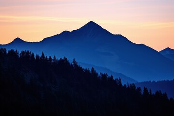 Majestic mountain range bathed in twilight hues silhouette dusk