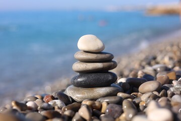 Stack of wet stones near sea on beach, closeup
