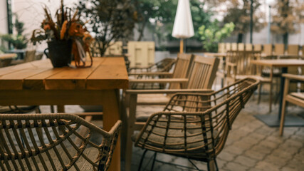 Outdoor cafe setting with wooden furniture and decorative elements