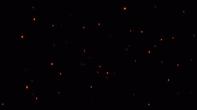Bright burning fire particles slowly rising on a black night sky. Hot glowing fire sparks and fiery ember ashes flying with the wind. Heat of a bonfire, blaze, and wildfire. Fire background. 4k.