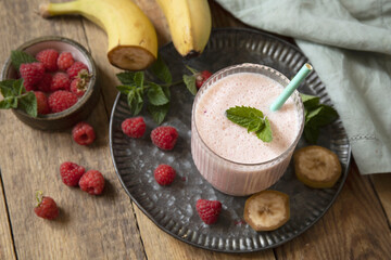 Refreshing banana raspberry smoothie with fresh mint for healthy living and summer enjoyment.