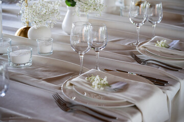 beautiful table setting with flowers and cutlery on wooden table at wedding or dinner. stylish tablewear decorations	
