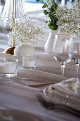 beautiful table setting with flowers and cutlery on wooden table at wedding or dinner. stylish tablewear decorations	