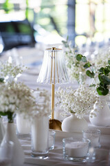 beautiful table setting with flowers and cutlery on wooden table at wedding or dinner. stylish tablewear decorations	
