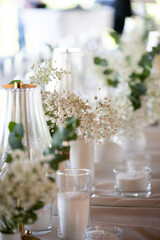 beautiful table setting with flowers and cutlery on wooden table at wedding or dinner. stylish tablewear decorations	