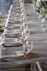 beautiful table setting with flowers and cutlery on wooden table at wedding or dinner. stylish tablewear decorations	
