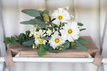 White floral bouquet with roses and daisies arranged in elegant vase for wedding table decoration, natural fresh flowers as romantic festive centerpiece for ceremony, celebration and reception event