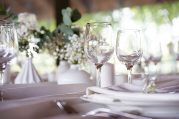 beautiful table setting with flowers and cutlery on wooden table at wedding or dinner. stylish tablewear decorations	