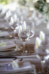 beautiful table setting with flowers and cutlery on wooden table at wedding or dinner. stylish tablewear decorations	