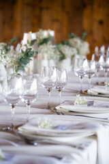 beautiful table setting with flowers and cutlery on wooden table at wedding or dinner. stylish tablewear decorations	