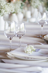 beautiful table setting with flowers and cutlery on wooden table at wedding or dinner. stylish tablewear decorations	