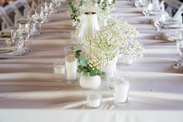 beautiful table setting with flowers and cutlery on wooden table at wedding or dinner. stylish tablewear decorations	