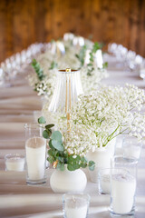 beautiful table setting with flowers and cutlery on wooden table at wedding or dinner. stylish tablewear decorations	