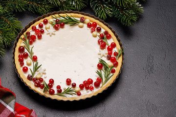 Christmas cake adorned with berries and rosemary