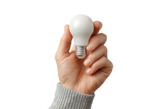 Female hand holding white light bulb isolated on black background, cut out