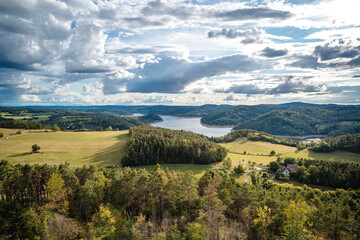 Obraz premium View from Milada Lookout Tower near Orlik Dam with meadows, forest and water surface